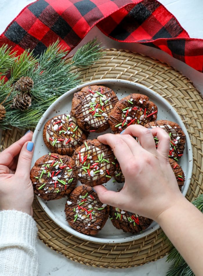 Keto Hot Cocoa Cookies on a plate and one being held in a hand.