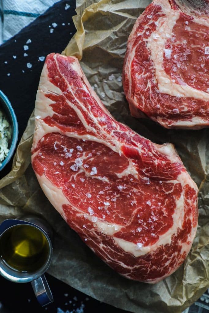 Raw ribeye bone-in steak