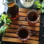 How To Make Homemade Keto Kahlua in two shot glasses on a brown tray