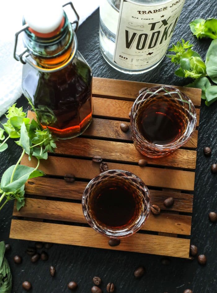 How To Make Homemade Keto Kahlua in two shot glasses on a brown tray