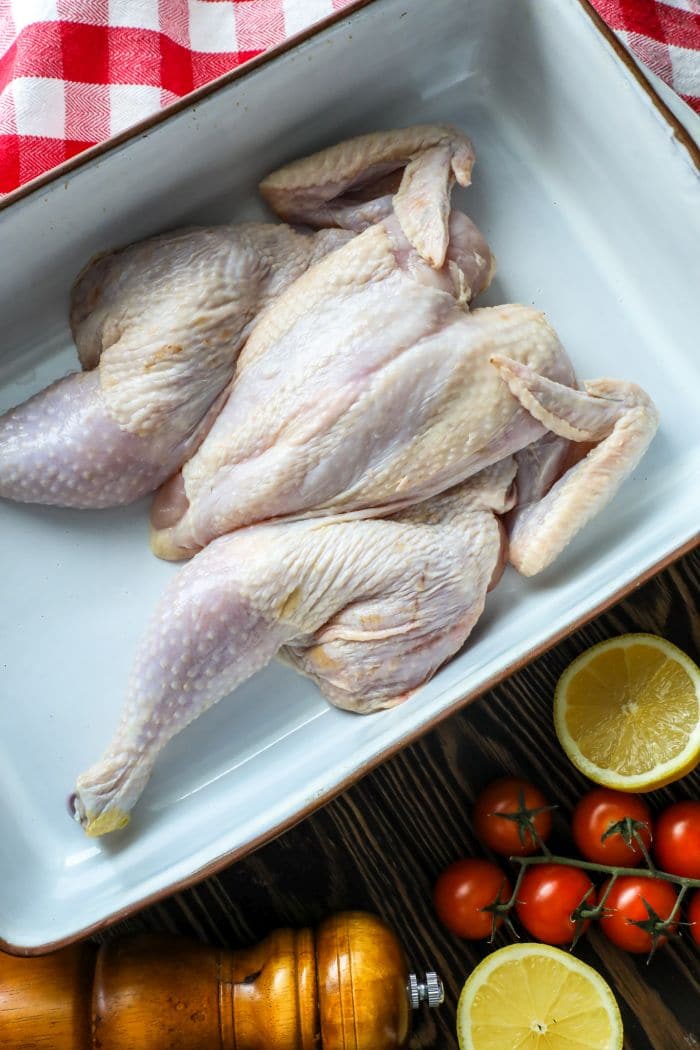 How To Roast Or Grill A Spatchcock Chicken - Raw chicken in a pan