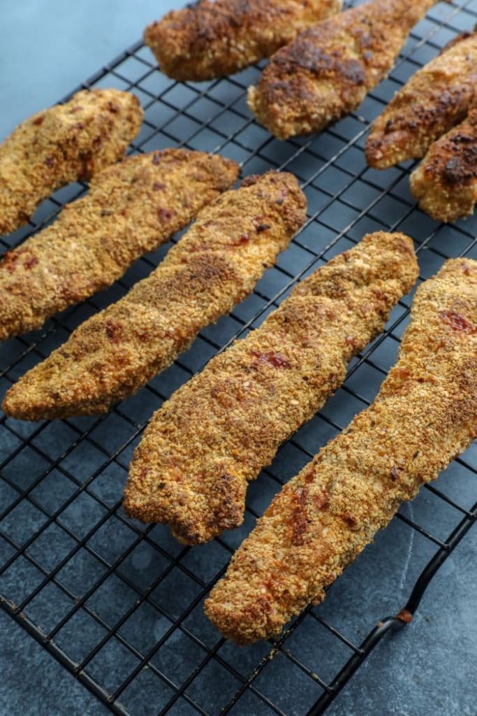 Crispy Almond Flour Cajun Chicken Tenders on a cooling rack.