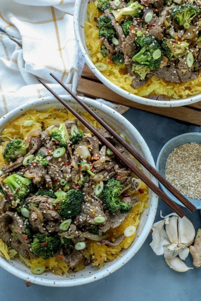 Two bowls of beef and broccoli with spaghetti squash