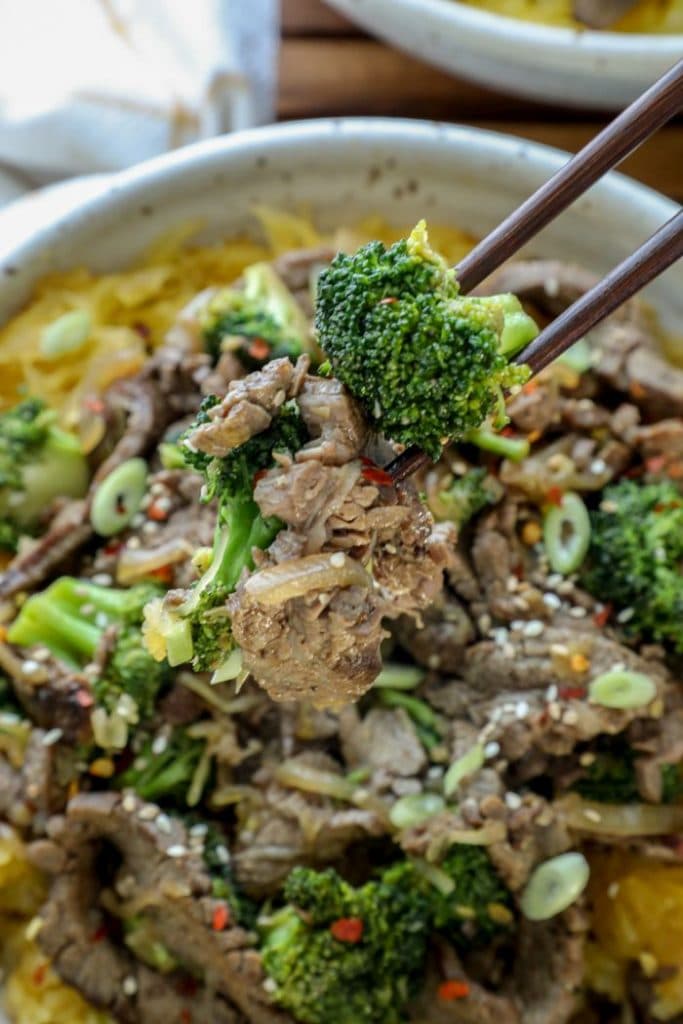 A big bowl of Beef and Broccoli with Spaghetti Squash with chopsticks