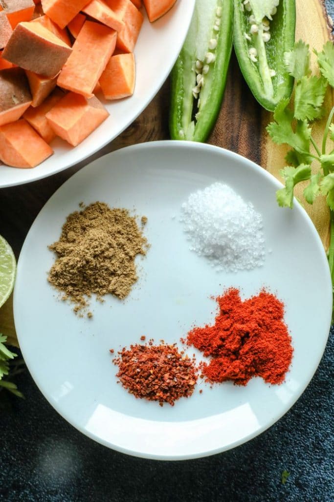 Spicy and Smoky Cumin Roasted Sweet Potato spice blend on a white plate. 