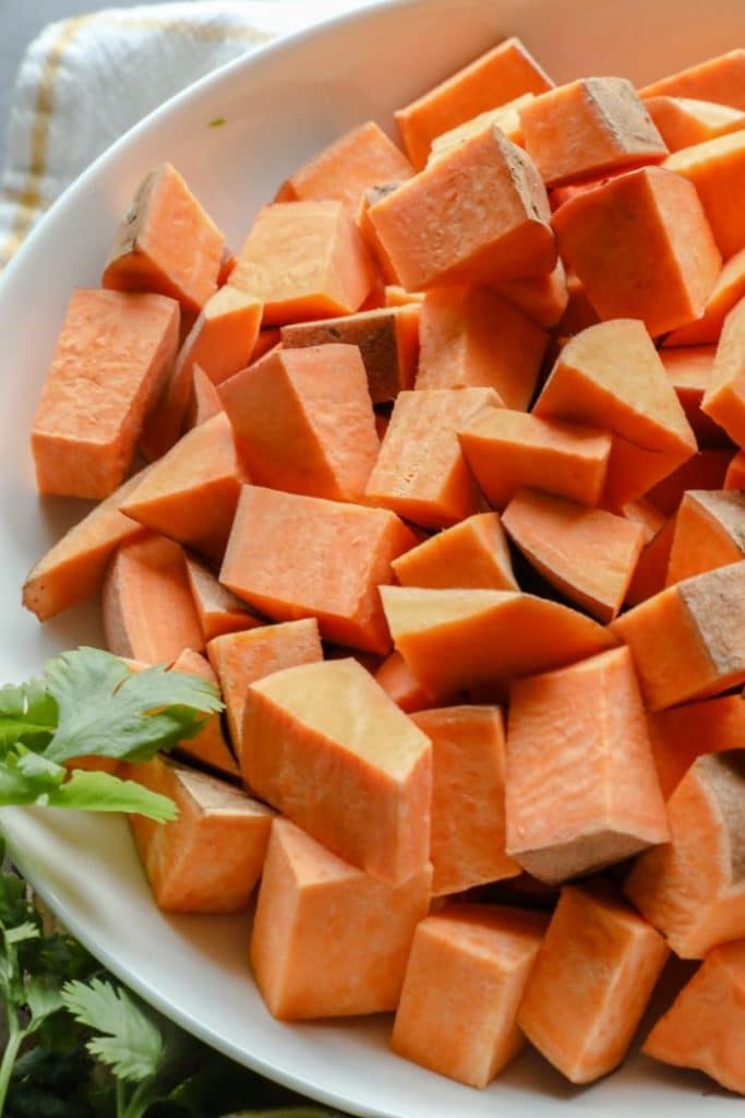 Diced, raw sweet potato chunks in a bowl