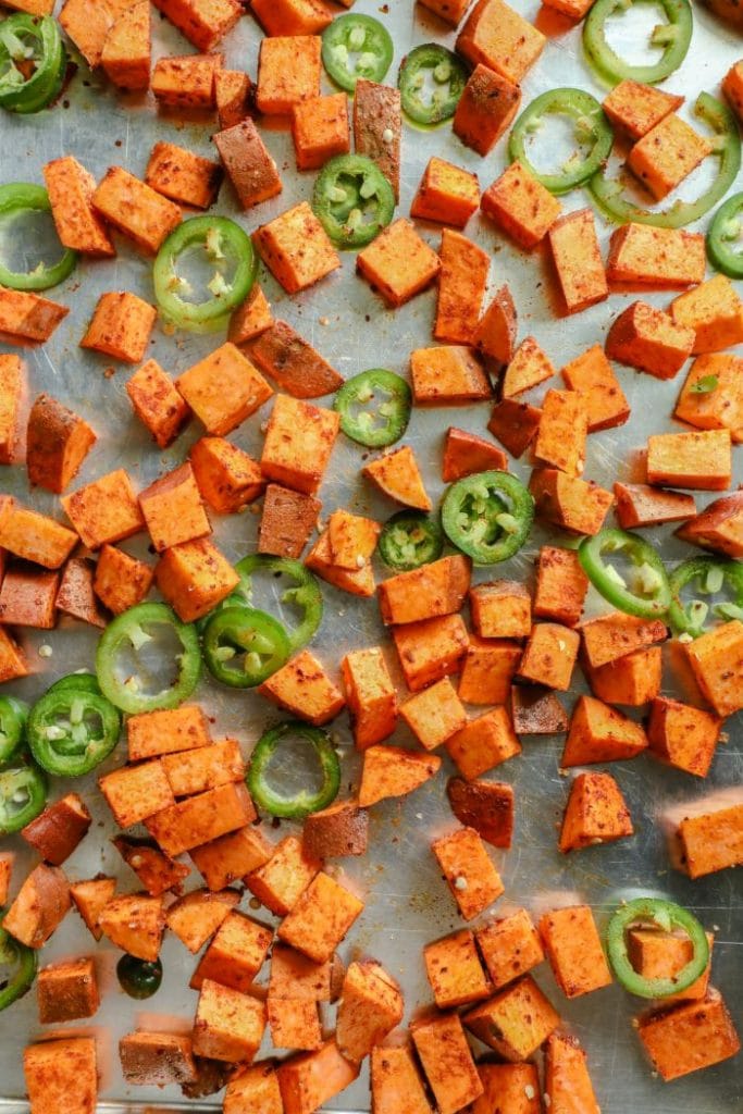 Spicy and Smoky Cumin Roasted Sweet Potatoes on a baking sheet. 