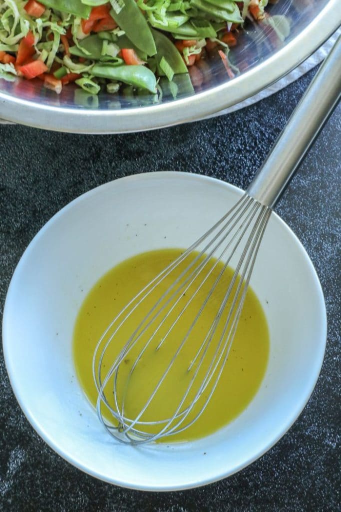 Brussel sprout slaw dressing in a bowl