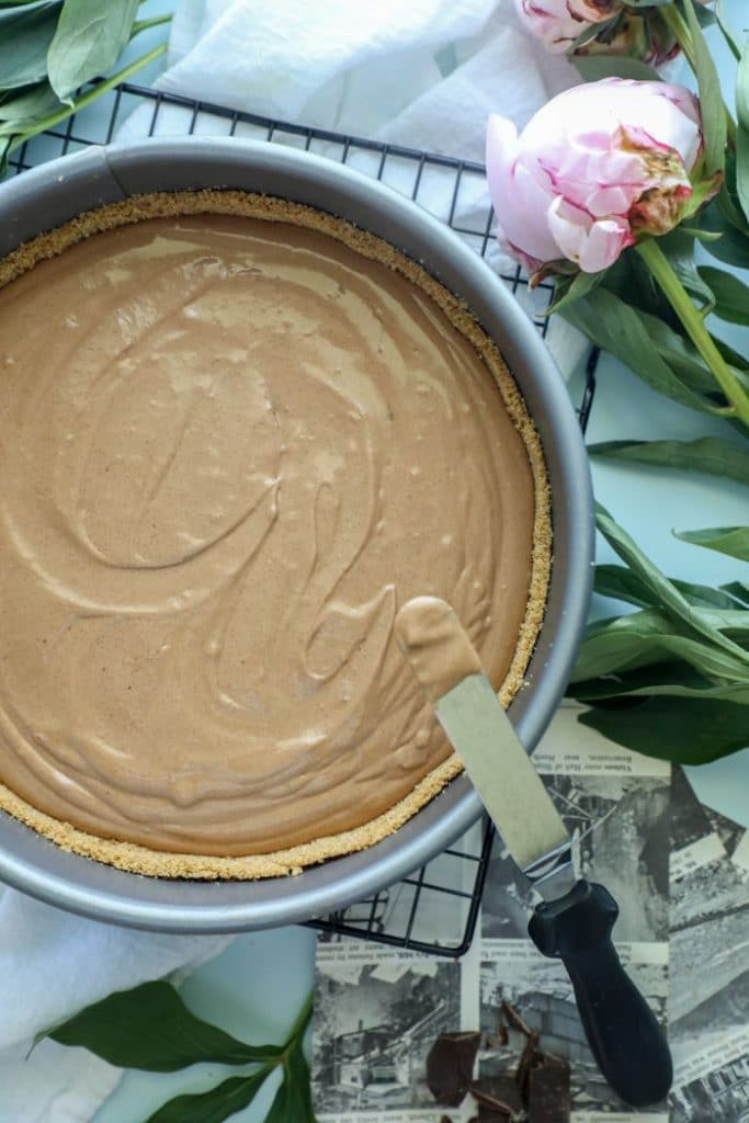 keto chocolate silk pie filling poured into the keto crust.