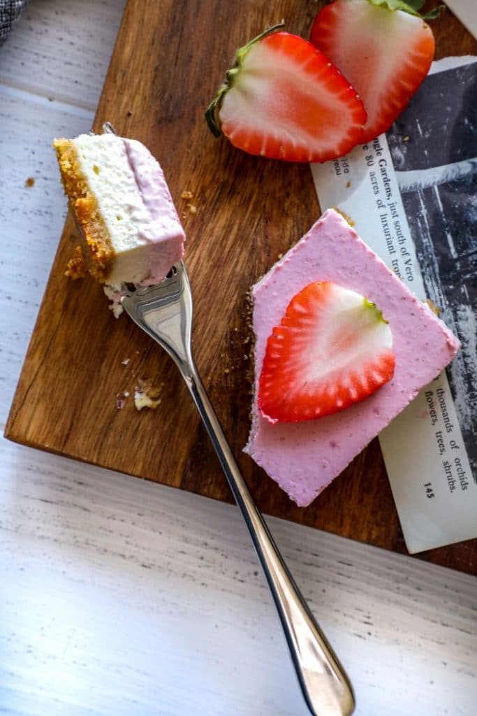 Easy Keto Strawberry Cheesecake Bar cut into with a fork.