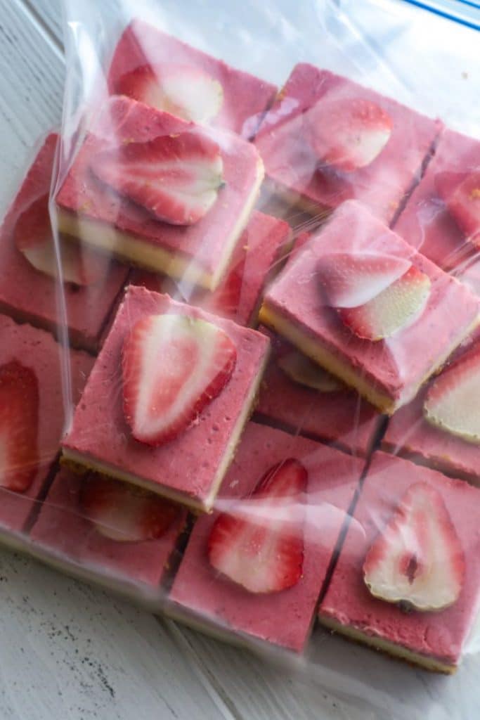 Frozen Easy Keto Strawberry Cheesecake Bars in a ziplock bag.