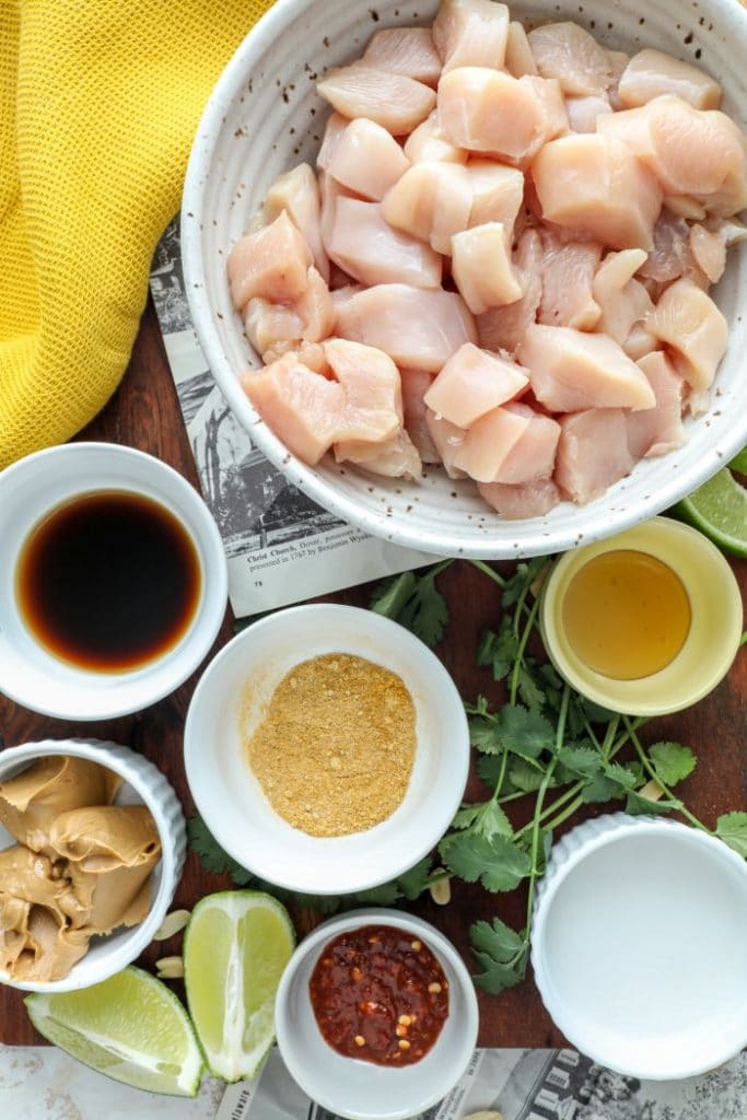 One pan Thai Chicken Satay ingredients on a brown board.