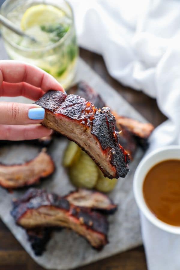 slow smoked ribs 3-2-1 held in a hand