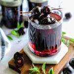 a glass filled with homemade maraschino cherries