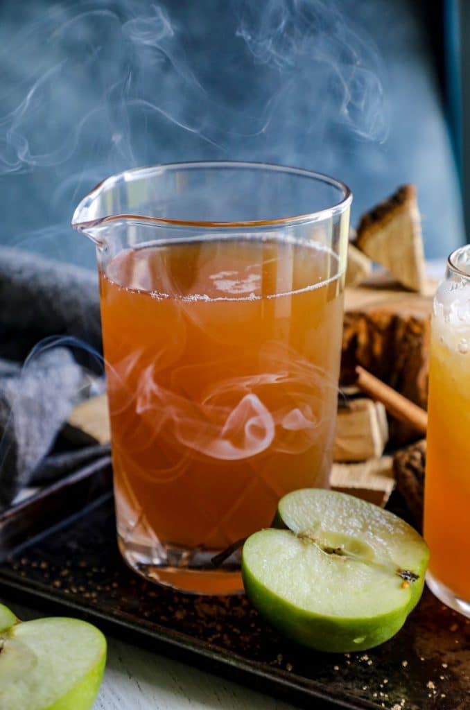 A pitcher of smoked apple cider