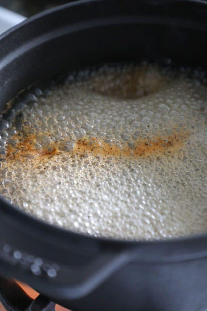 The apple cider brine boiling in a pot