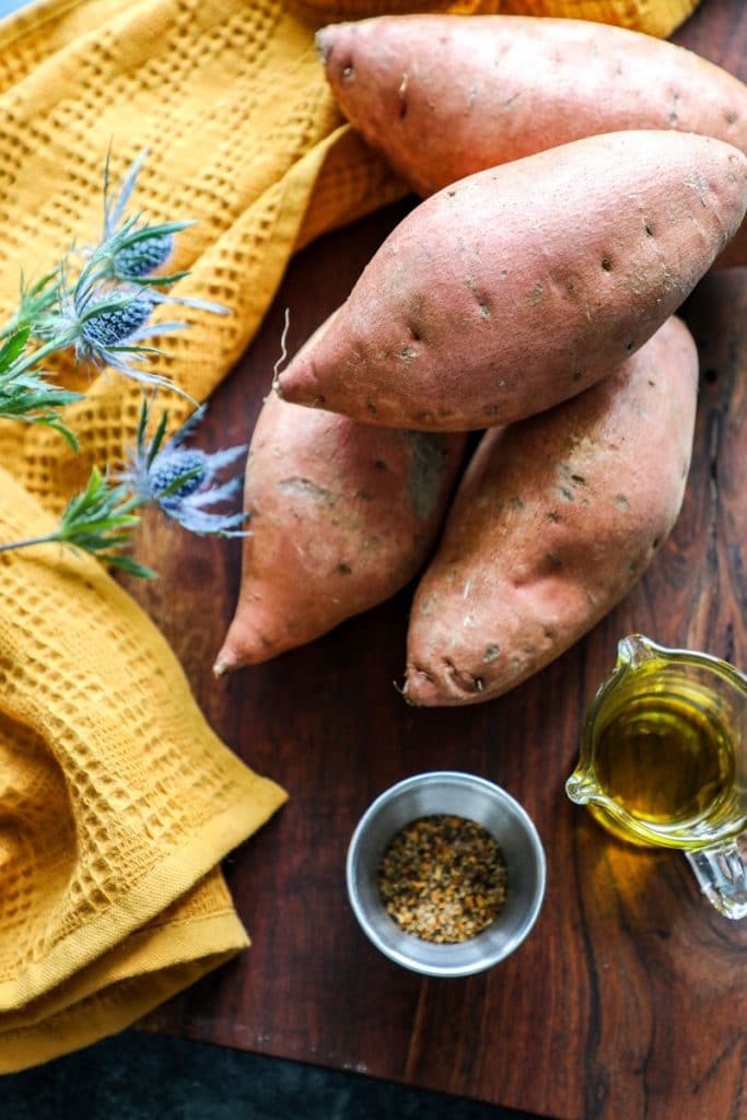 Raw sweet potatoes on a cutting board