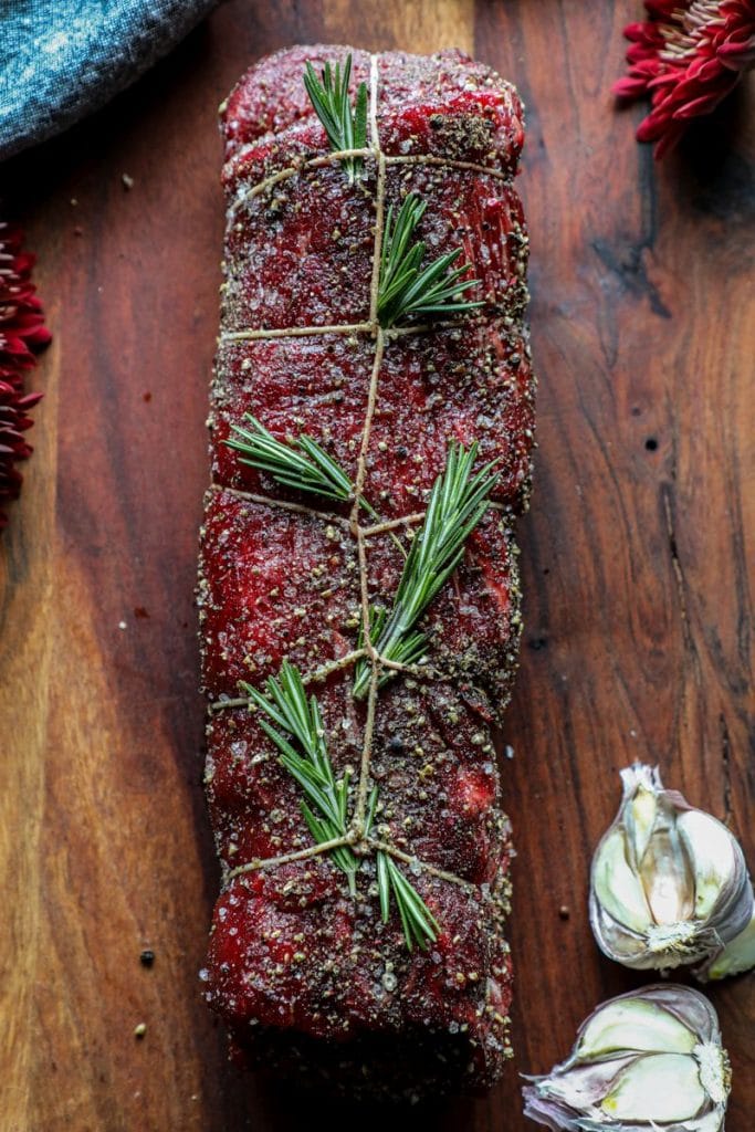 Oiled and seasoned beef tenderloin resting before smoking 