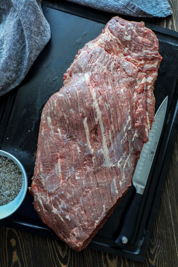 Raw full packer brisket on a cutting board 