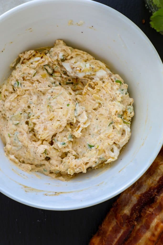 Jalapeno popper cream cheese filling in a white bowl.