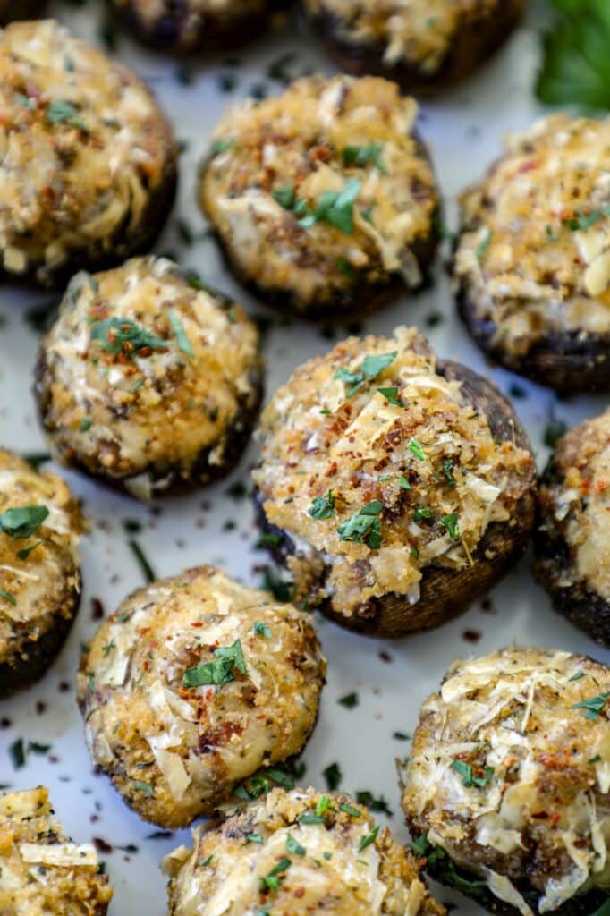 Smoked Stuffed Mushrooms lined up on a white background. 