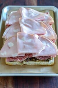 meat layered onto the muffuletta slider