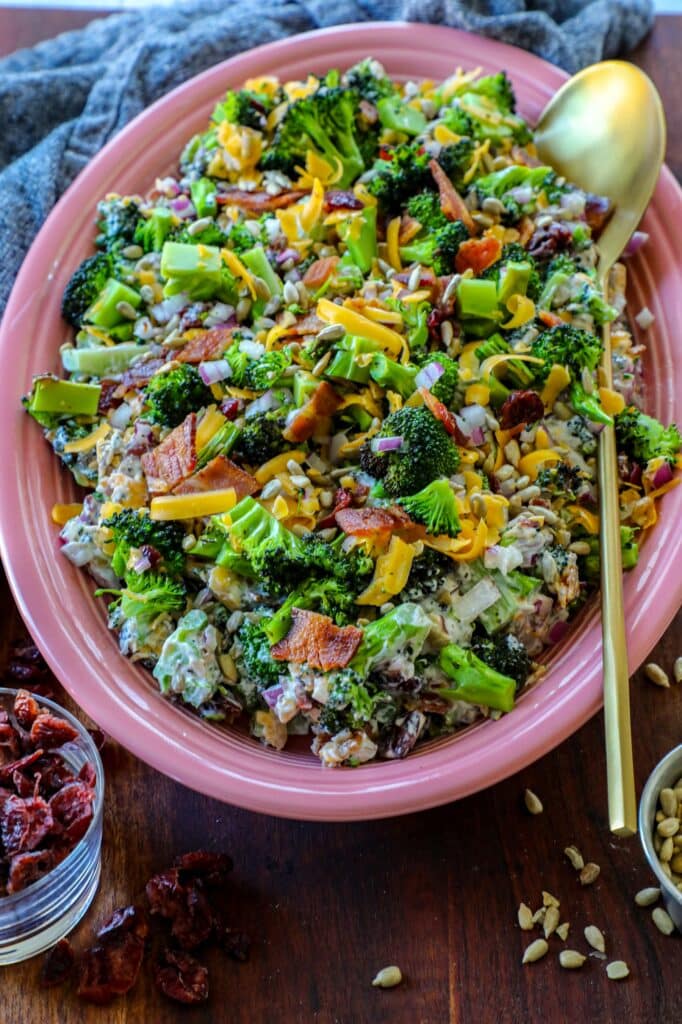 Grilled Broccoli Salad on a serving platter with a golden serving spoon. 
