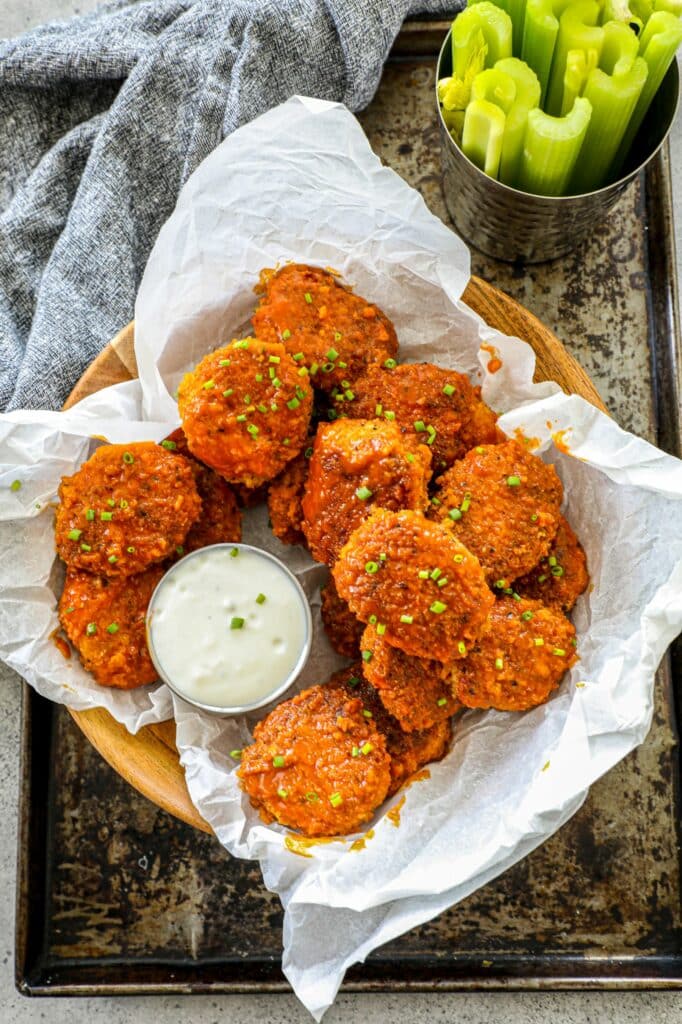 Buffalo Chicken Nuggets in a basket with a side of ranch. 