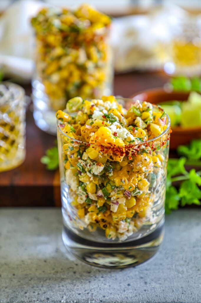 Grilled Esquites Recipes served in a small glass cup. 