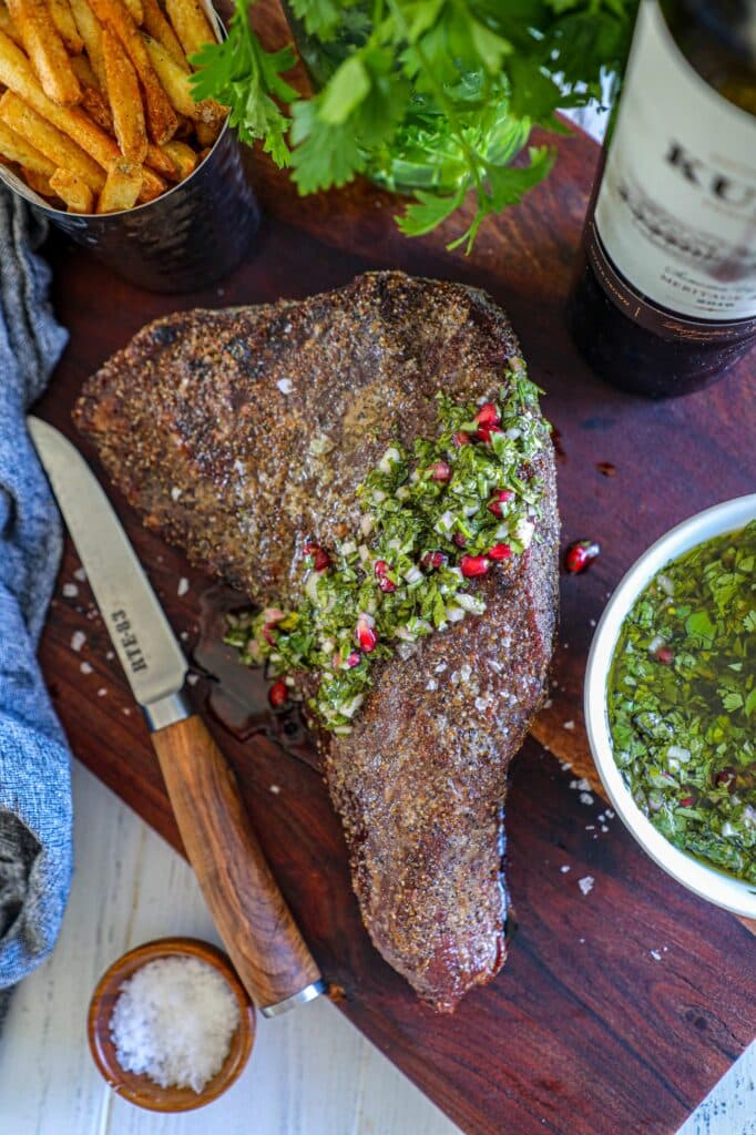 Oven Roasted Tri Tip Recipe with chimichurri on top 
