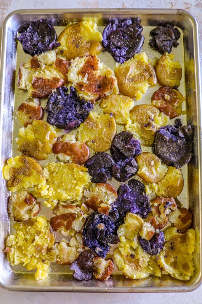 Freshly smashed potatoes that are seasoned before roasting 