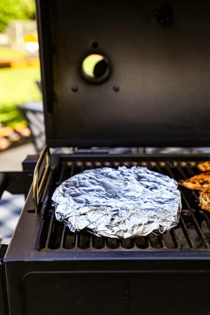 warming the pitas on the grill 
