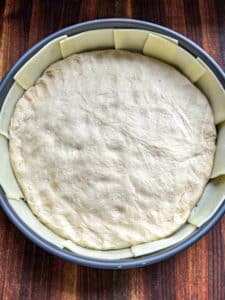 The dough added to the pan and pressed into it